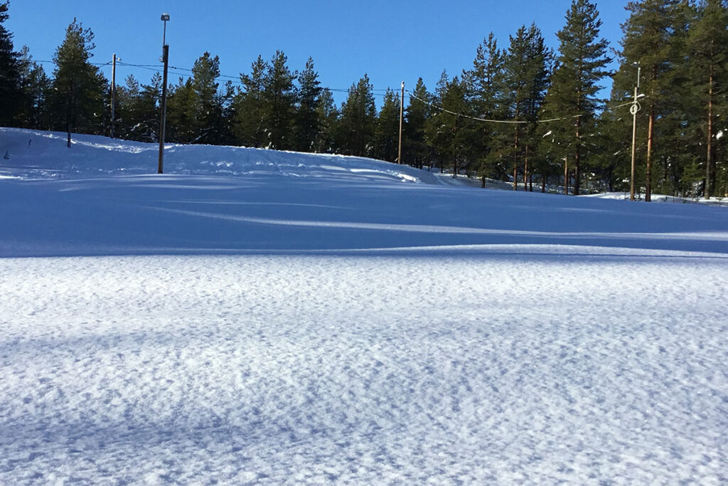 Sol som skiner på ett vinterlandskap.